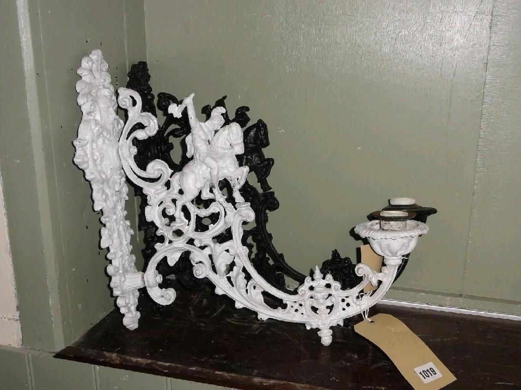 Appraisal: A pair of decorative cast iron single branch wall lights