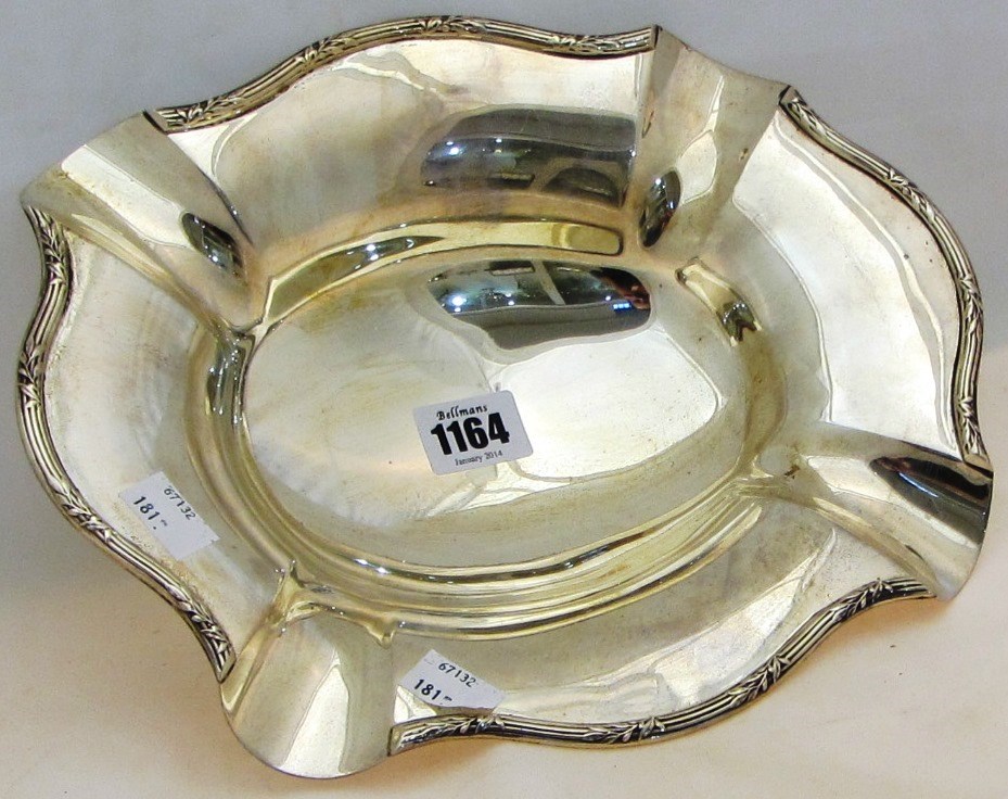 Appraisal: A silver shaped oval dish decorated with foliate motifs to