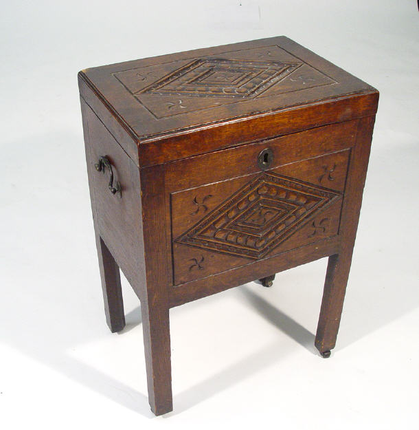 Appraisal: th Century oak cellarette the hinged lid and three panel