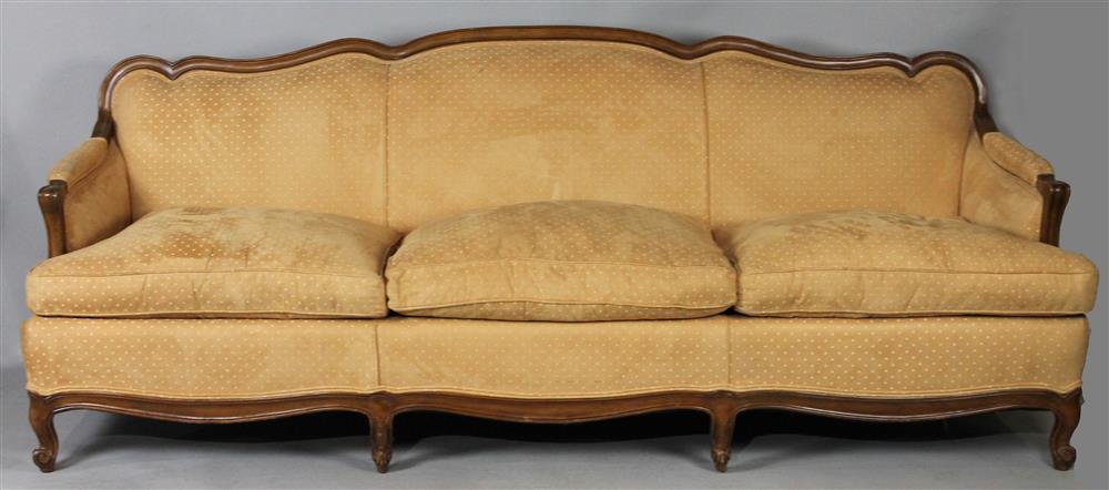 Appraisal: FRENCH PROVINICAL STYLE UPHOLSTERED FRUITWOOD SOFA having an exposed molded