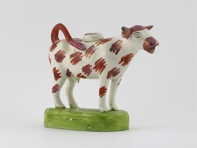 Appraisal: A lustre ware cow creamer and cover possibly Swansea decorated