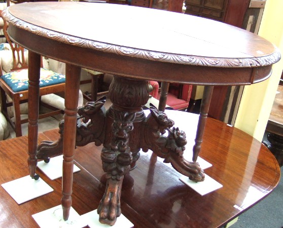 Appraisal: A French oak extending table the carved oval top raised