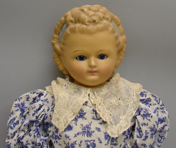 Appraisal: Unmarked wax over papier mache shoulderhead doll Stationary blue glass