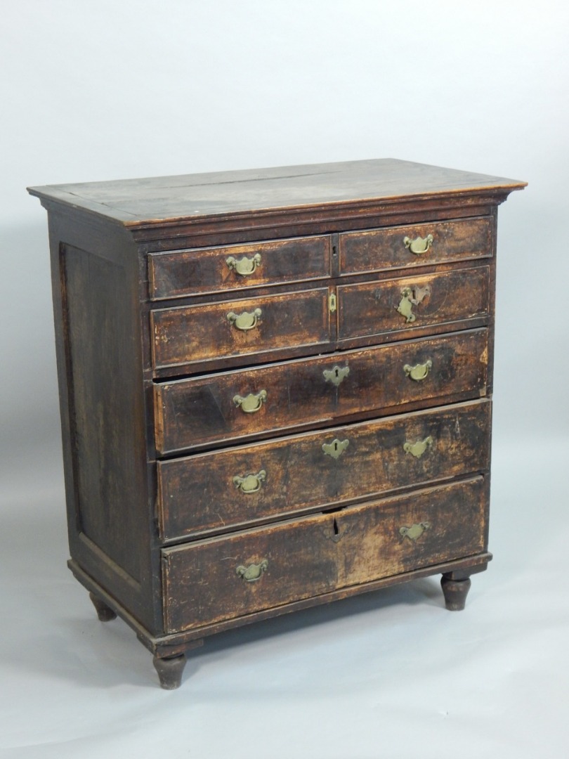 Appraisal: A mid thC walnut and oak chest of drawers with