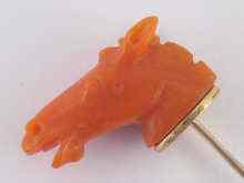 Appraisal: A carved coral stick pin designed as a horse's head