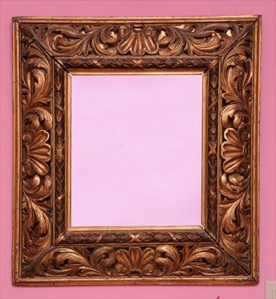 Appraisal: BAROQUE-STYLE CARVED GILTWOOD WALL MIRROR The rectangular mirror plate in