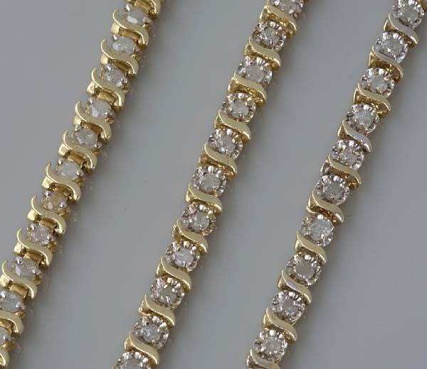 Appraisal: A collection of three diamond and gold tennis bracelets Lengths