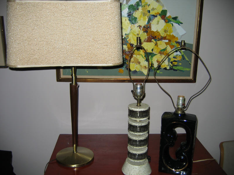 Appraisal: THREE MID-CENTURY TABLE LAMPS Black pottery enameled metal and wood