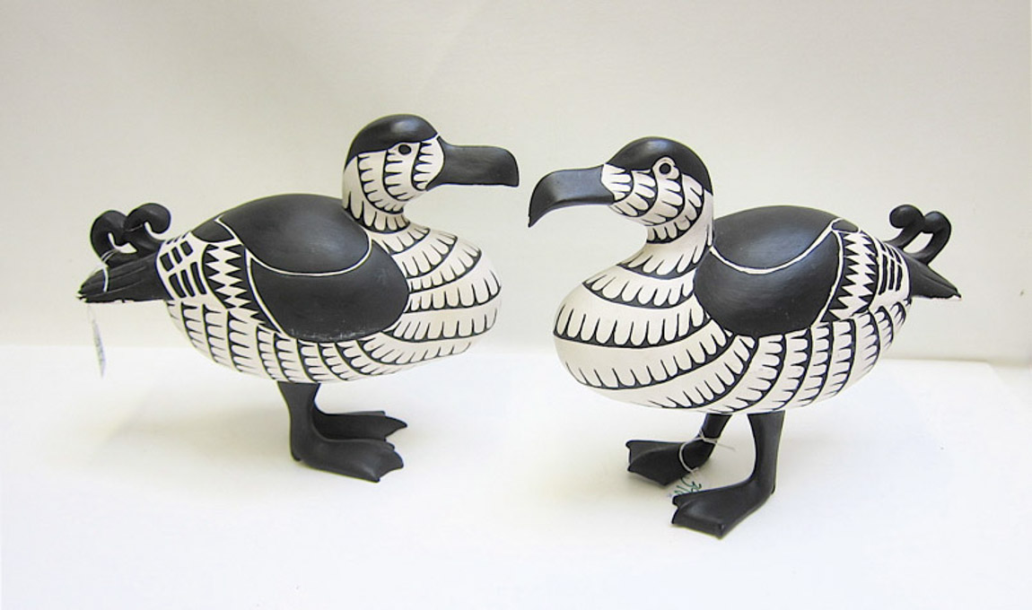 Appraisal: PAIR HAND CARVED AND PAINTED WOOD DUCKS in black and