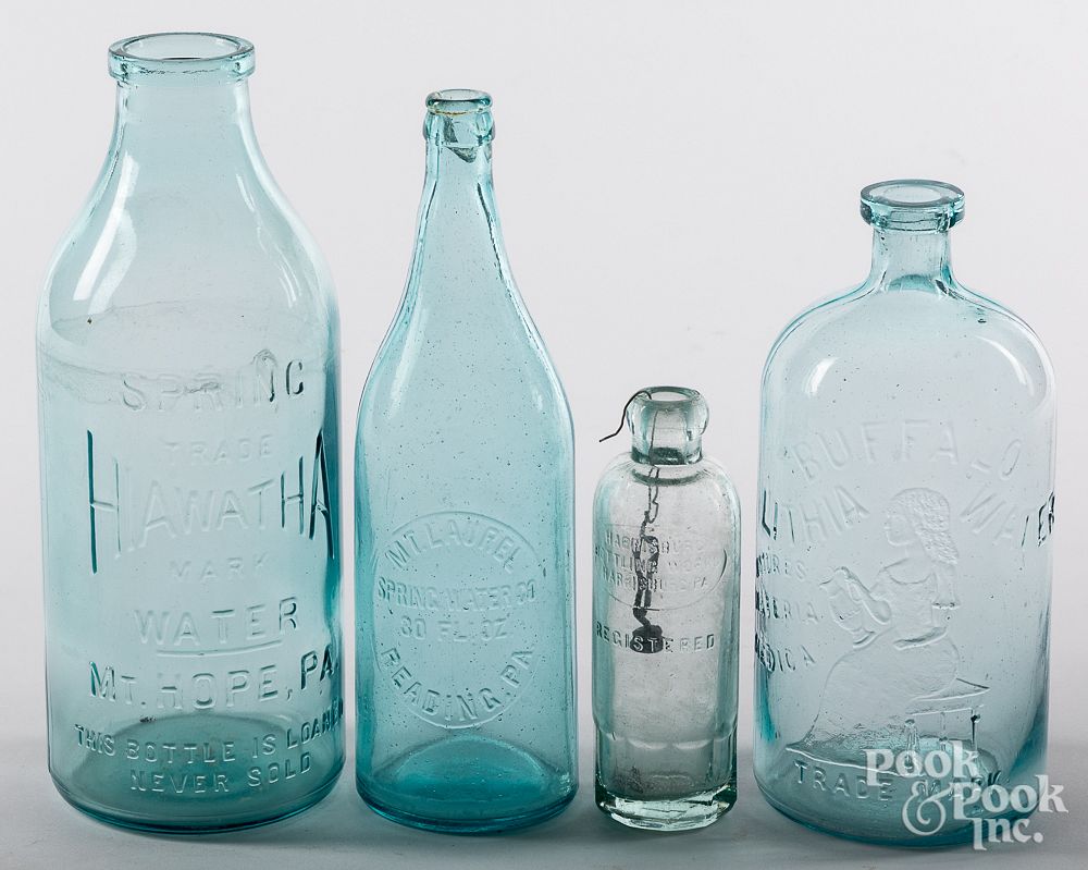 Appraisal: Four colorless glass bottles th th c Four colorless glass