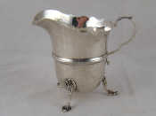 Appraisal: A silver helmet cream jug on three shell feet with