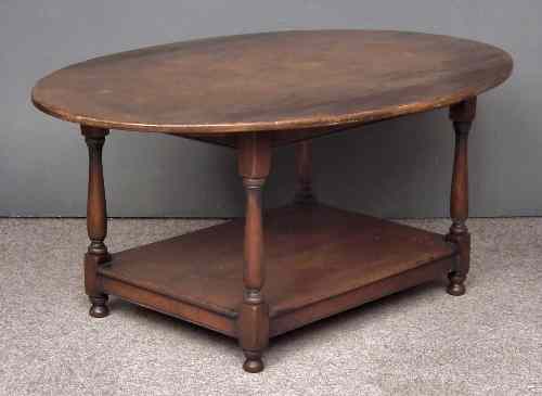 Appraisal: An oak oval coffee table of '' th Century'' design