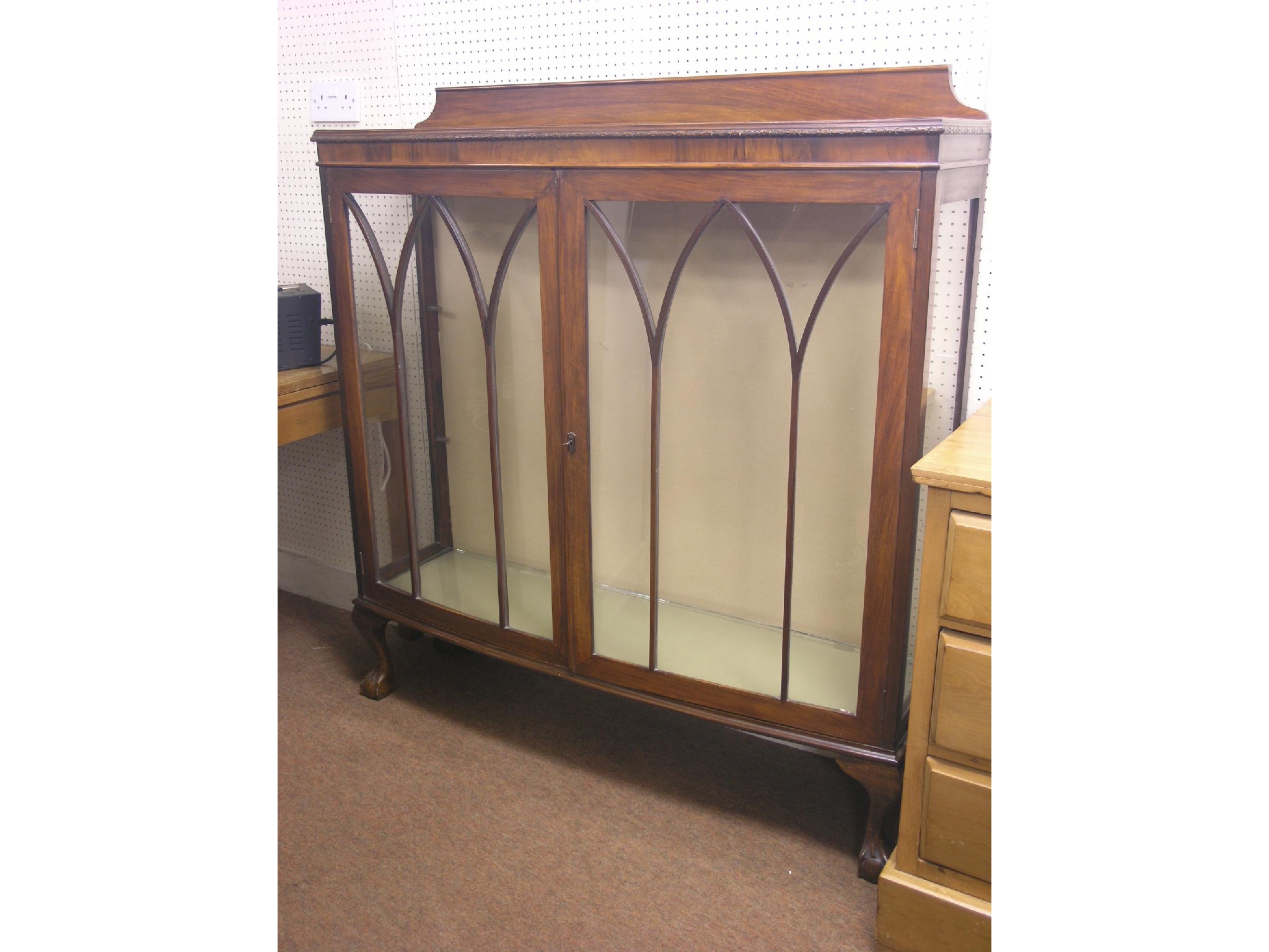 Appraisal: A walnut display cabinet bow-fronted two plate glass shelves enclosed