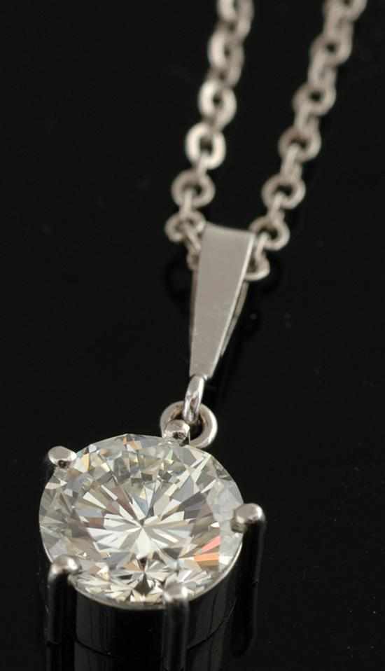 Appraisal: A diamond pendant The claw set round brilliant cut diamond