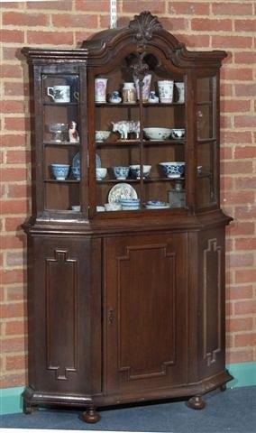 Appraisal: A DUTCH OAK VITRINE the glazed upper half fitted shaped