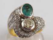 Appraisal: A yellow metal tests ct gold diamond and emerald ring