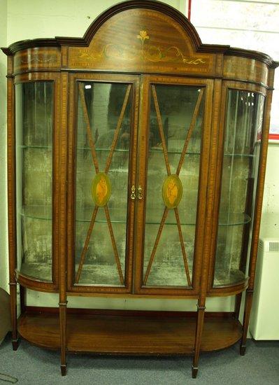 Appraisal: An Edwardian mahogany and inlaid breakfront display cabinet the arched