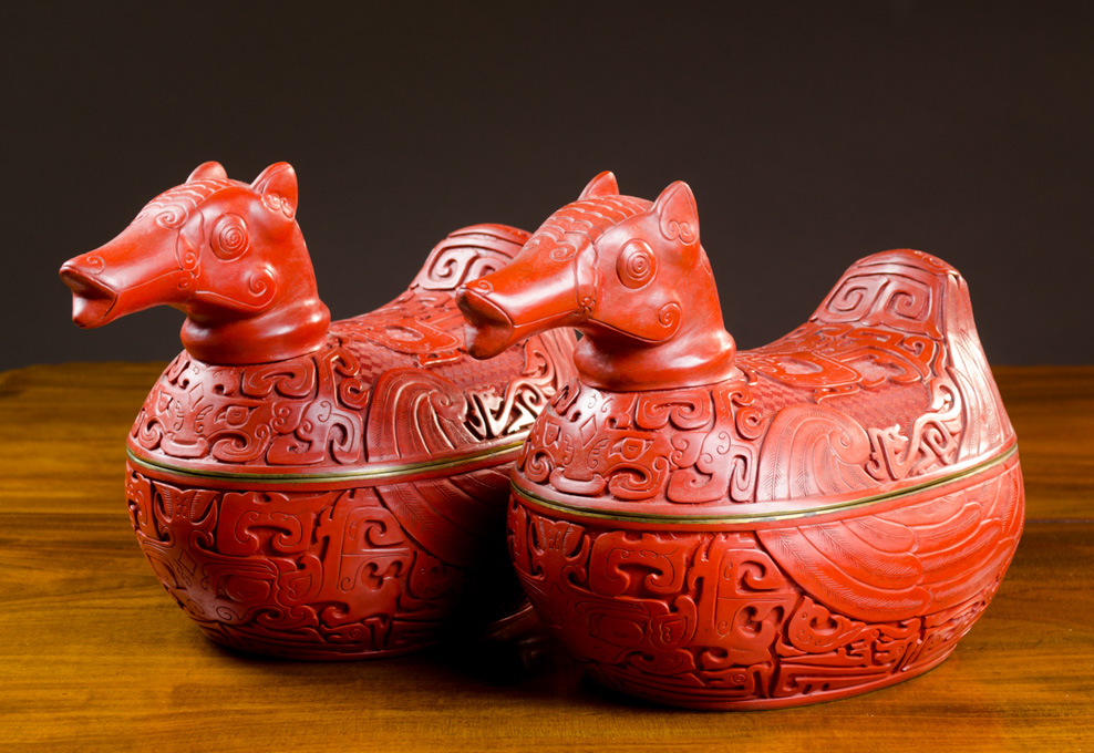 Appraisal: PAIR CHINESE CINNABAR STYLED FIGURAL COVERED DISHES in the form