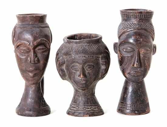 Appraisal: African carved wood kuba cups two tall and one squat