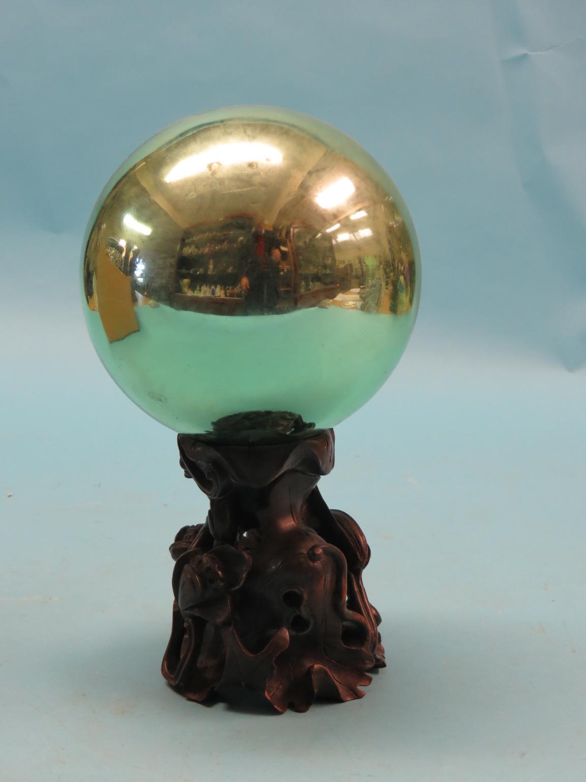 Appraisal: A lime-green witch's ball on Chinese carved hardwood stand in