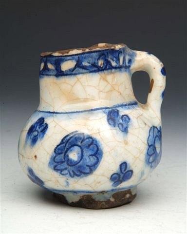 Appraisal: AN IZNIK POTTERY CHILD'S MUG with simple blue flower design