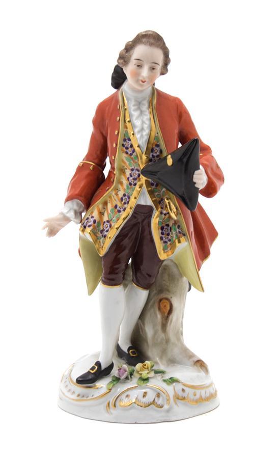 Appraisal: Continental Porcelain Figure depicting a man wearing an orange overcoat