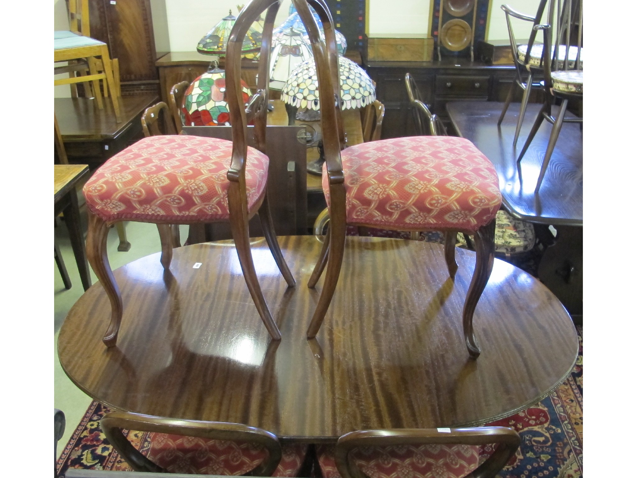 Appraisal: A mahogany dining table and six balloon back dining chairs